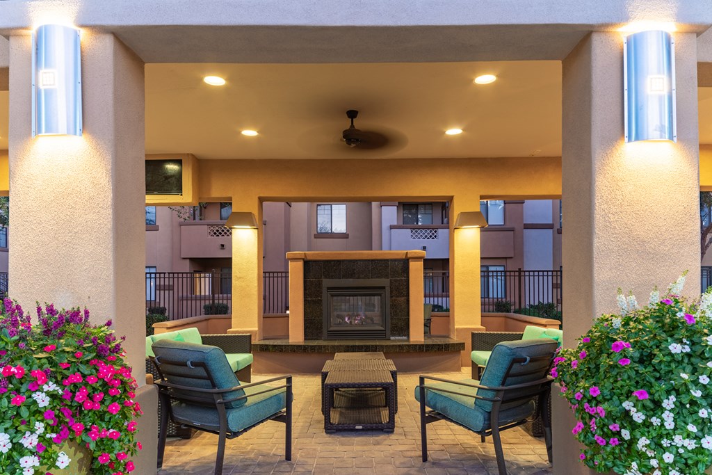 a lobby with a fireplace and seating area