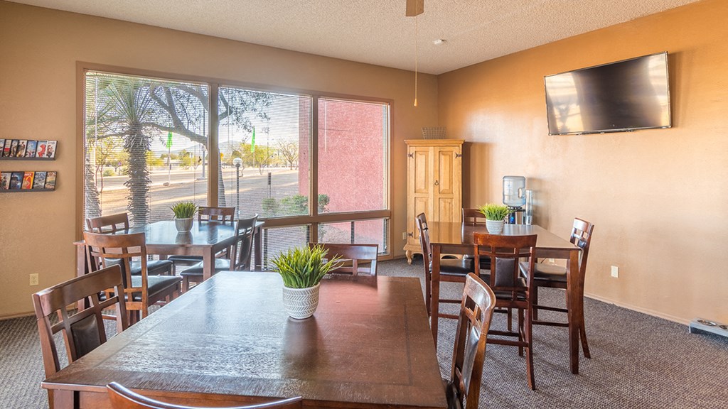 Spacious room with tables and seating and windows length of wall