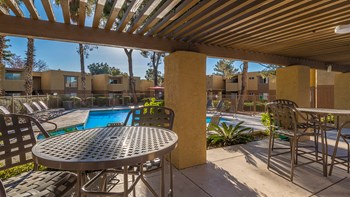 Rio Vista outside view of pool with plenty of lounging area and trees surrounding - Photo Gallery 4