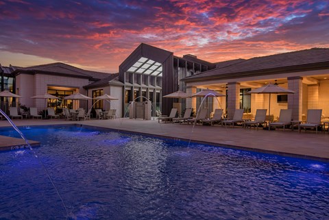 A large house with a pool in the foreground.