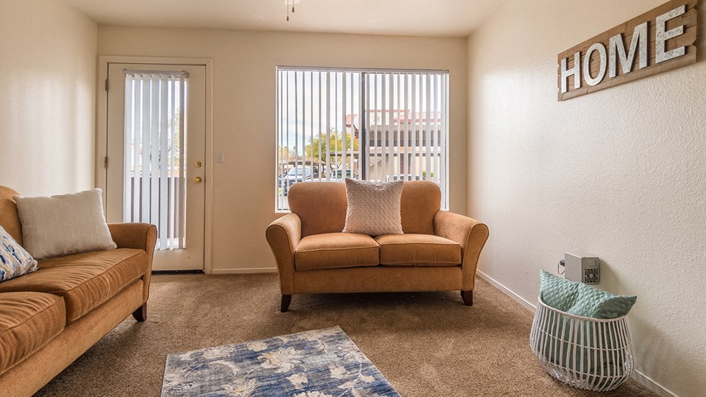 living room area with couch and large window and door with window
