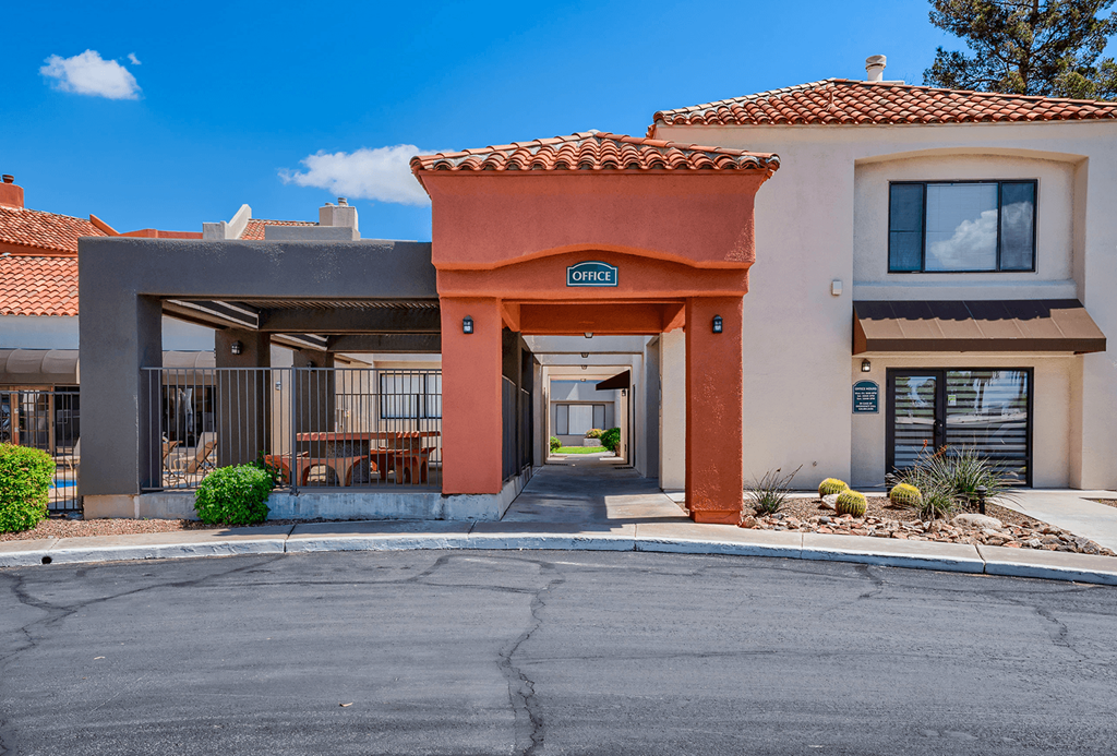 a building with a porch and a street in front of it