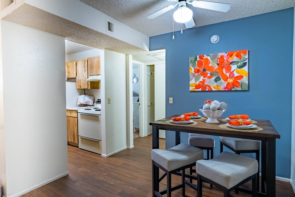 a dining room and kitchen with a table and chairs