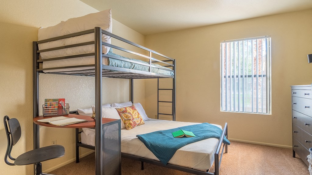 Enclave spacious bedroom with bed and bunk bed