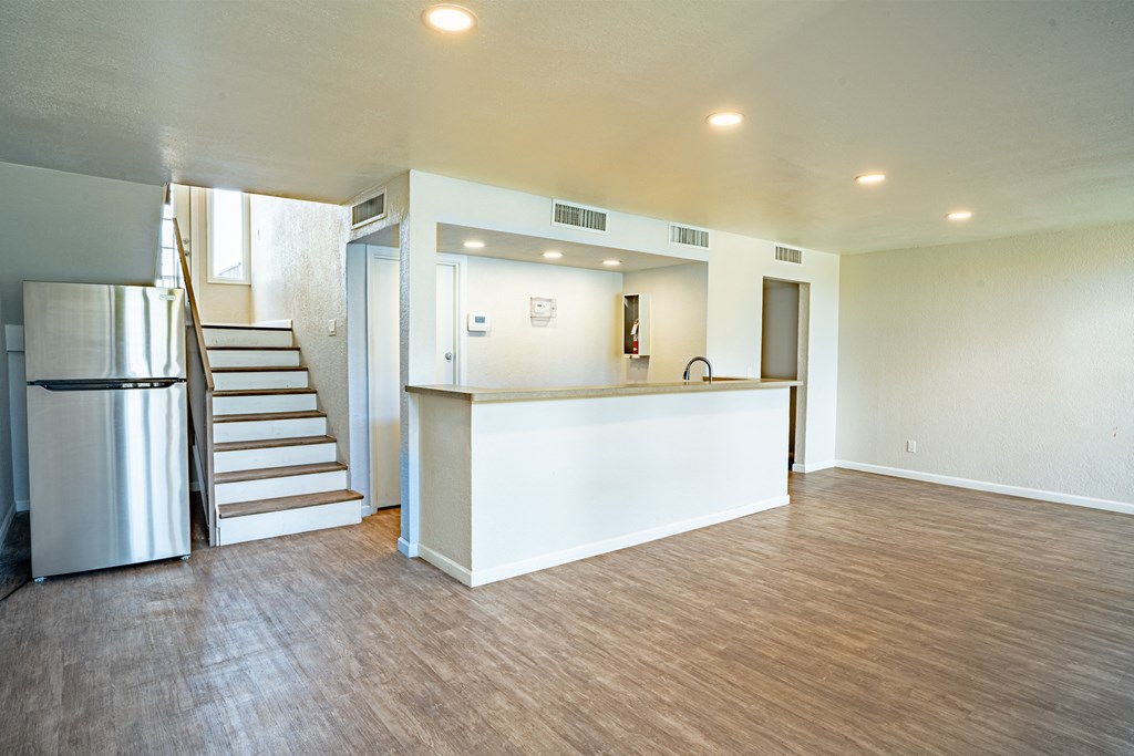 large open room with a bar top and stairs leading to the 2nd level