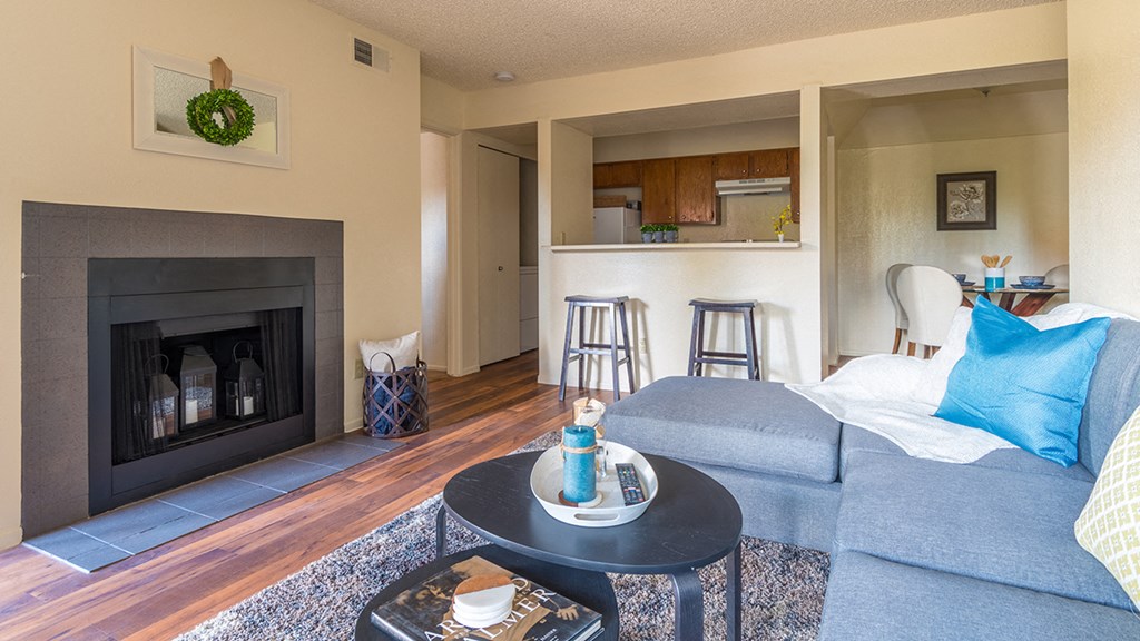 Enclave living room with cozy couches and wood-like flooring