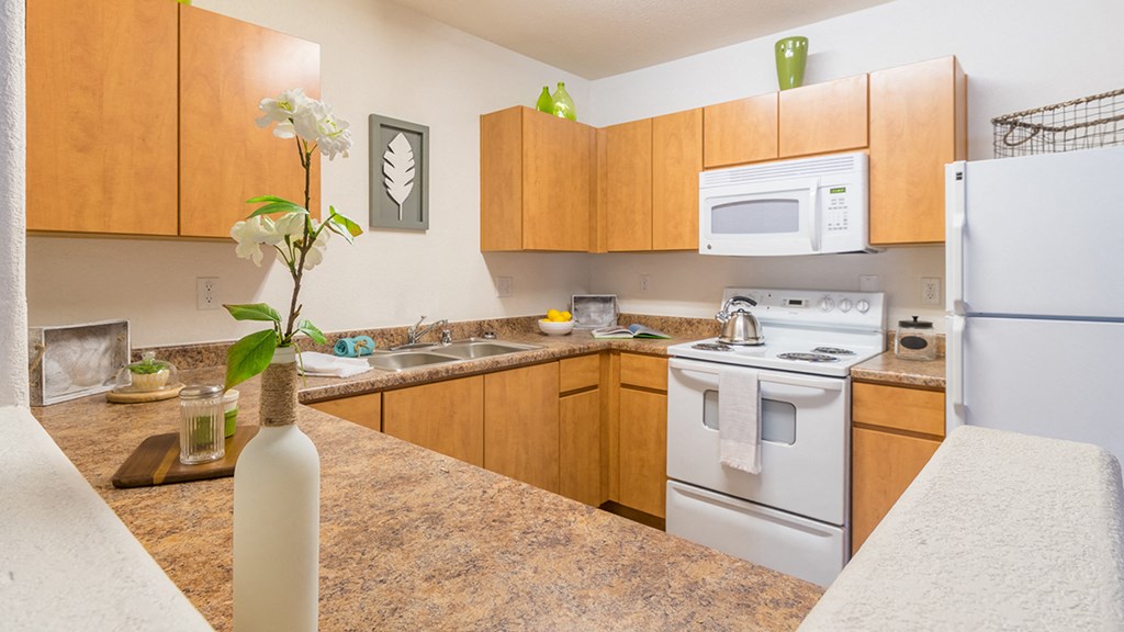Desert Sands kitchen equipped with all white appliances.