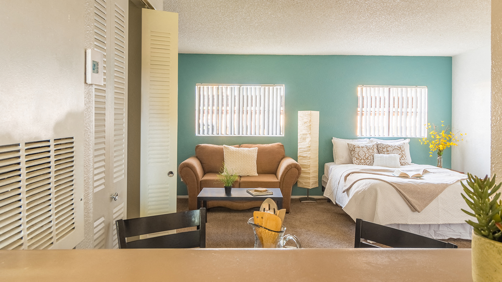 a living room with a couch and a bed