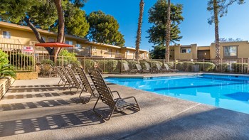 Rio Vista pool with plenty of lounging area and tall trees surrounding - Photo Gallery 5