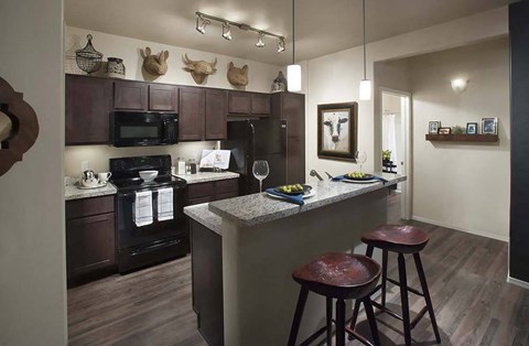 a kitchen with a bar and stools