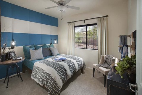 a bedroom with a bed and a ceiling fan