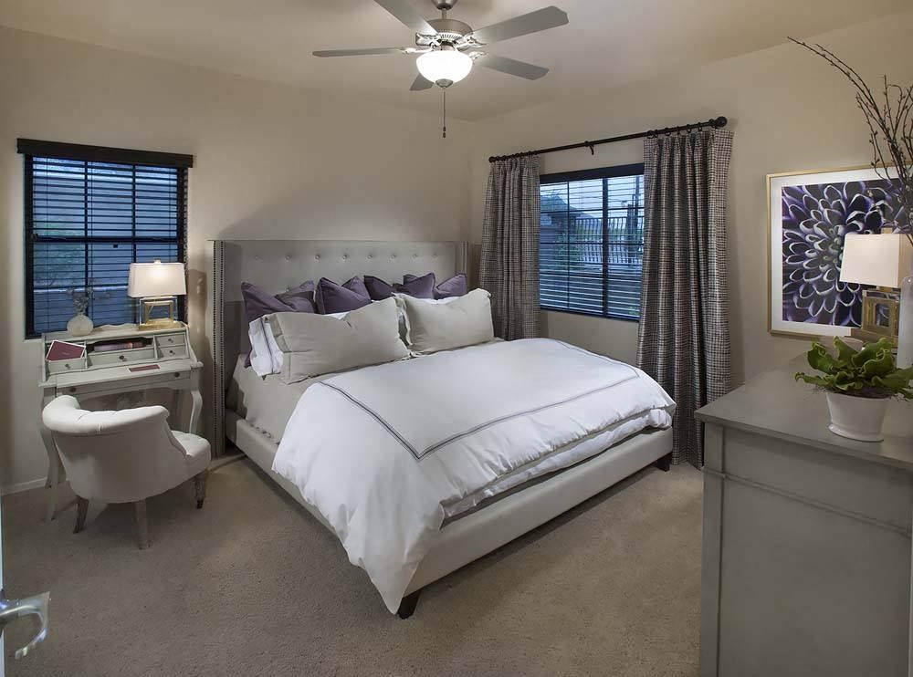a bedroom with a bed and a ceiling fan