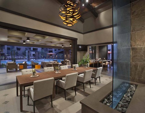 a dining room with a long table and chairs