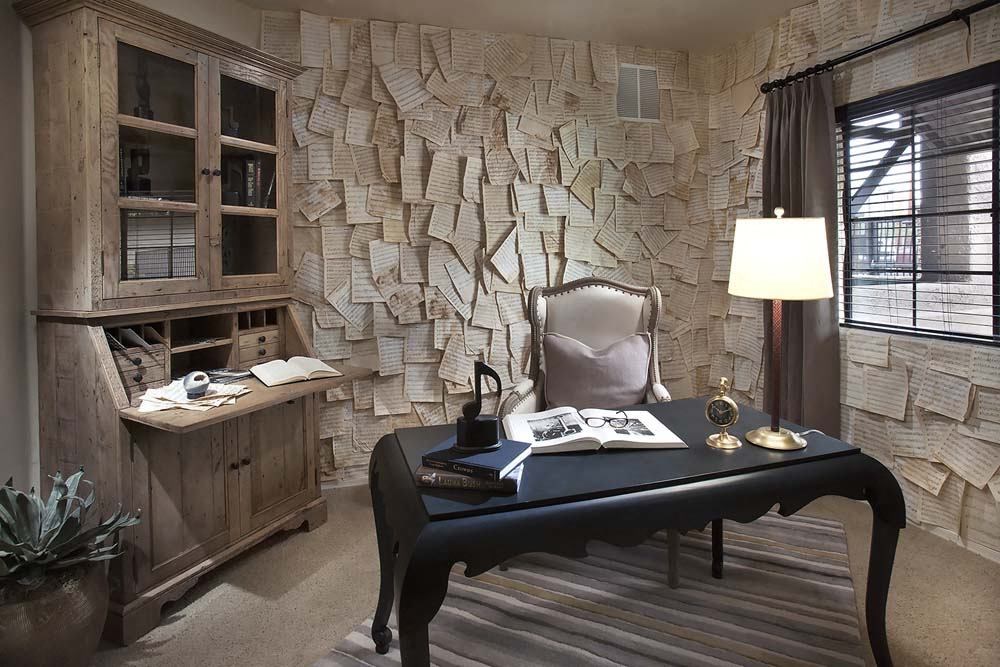 a office with a desk and a chair and a wall filled with papers