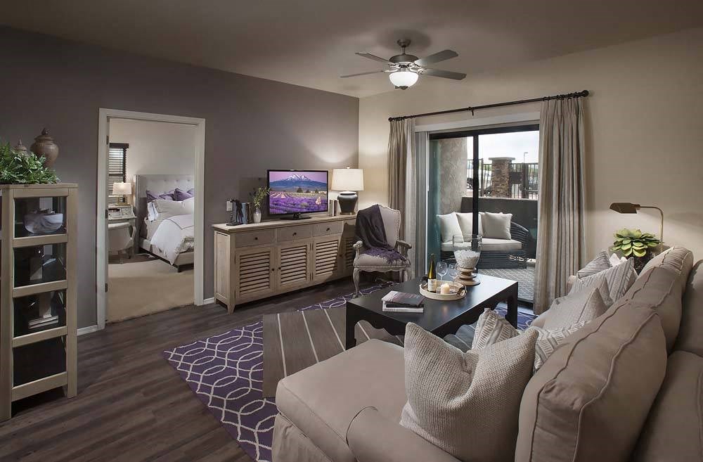 a living room with a couch and a ceiling fan