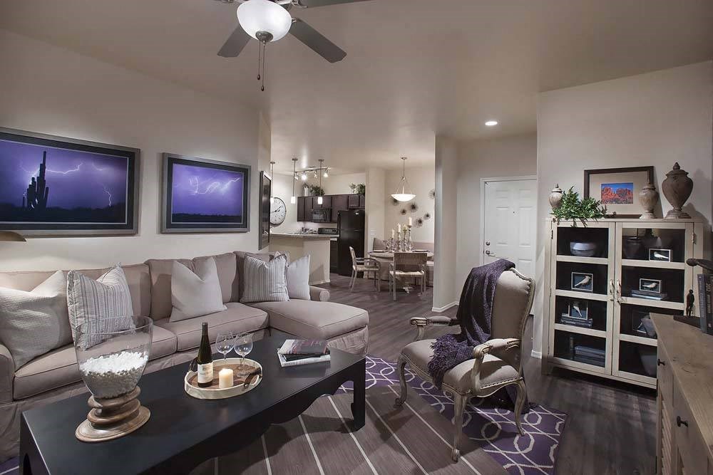 a bar with a row of wine glasses and a table with wine glasses