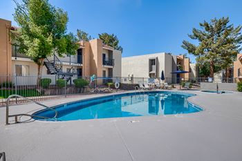A swimming pool in front of apartment buildings.