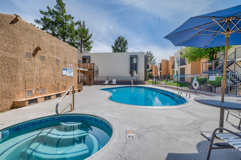 our apartments have a large pool and patio with umbrellas
