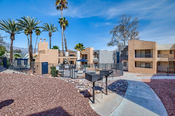 A modern residential area with houses and palm trees.