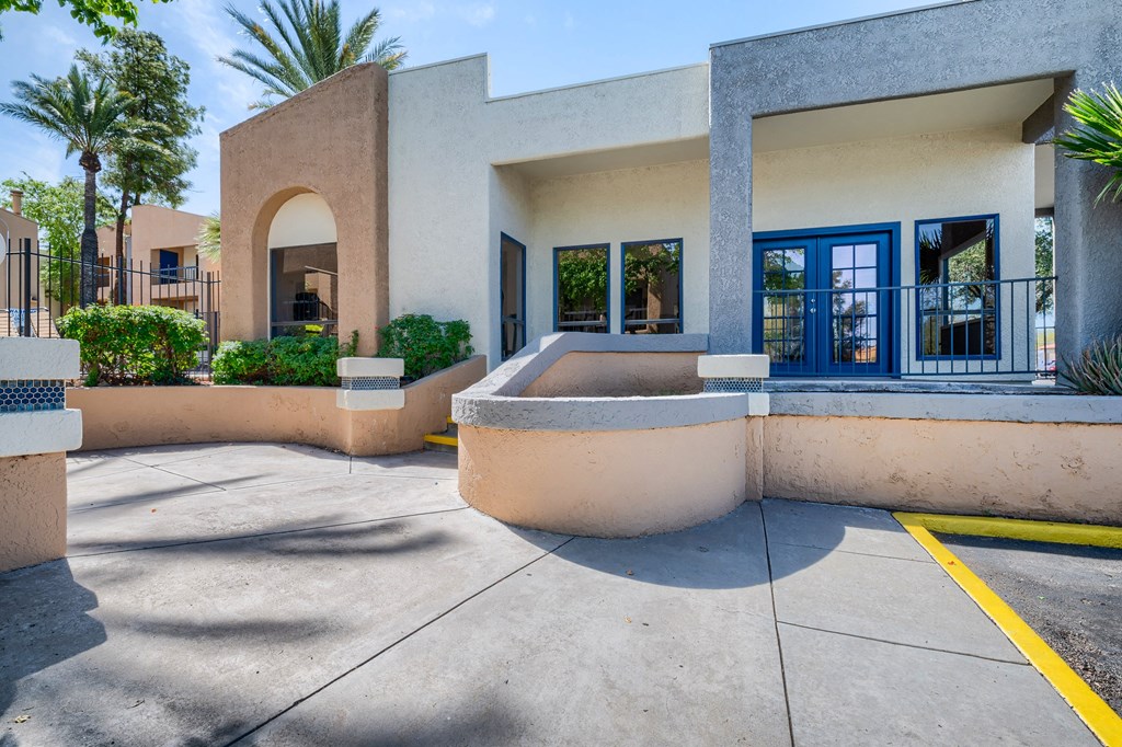 the entrance to a building with a courtyard and a swimming pool