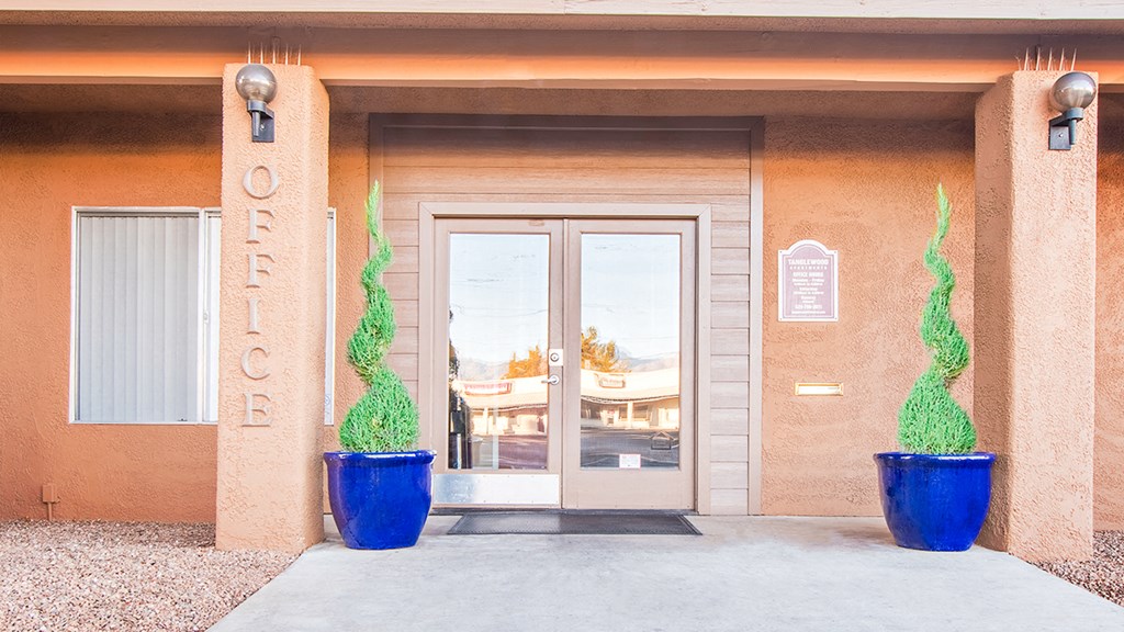 Tanglewood  clubhouse entrance with well kept path and glass doors