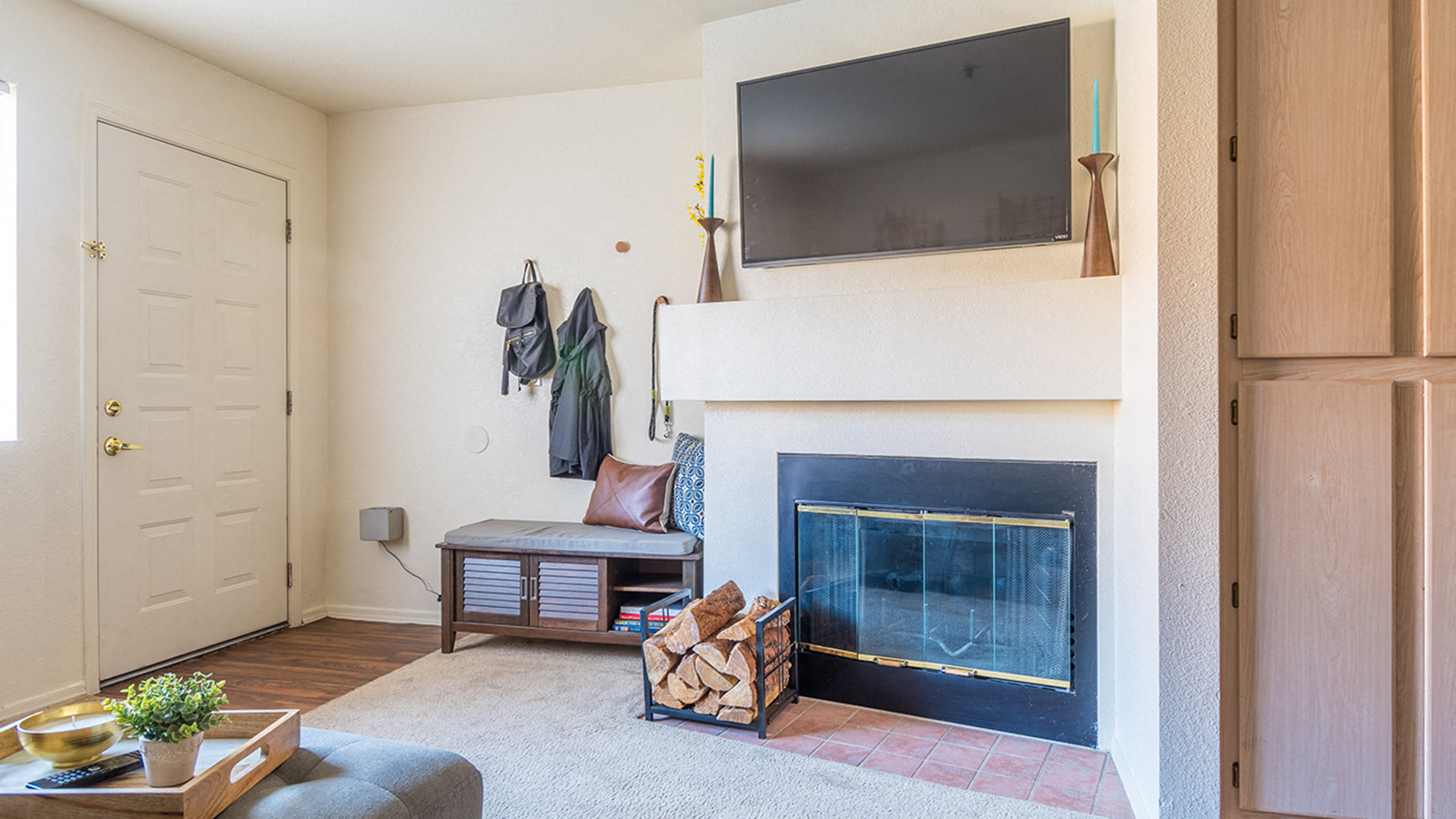 a living room with a fireplace and a tv above it
