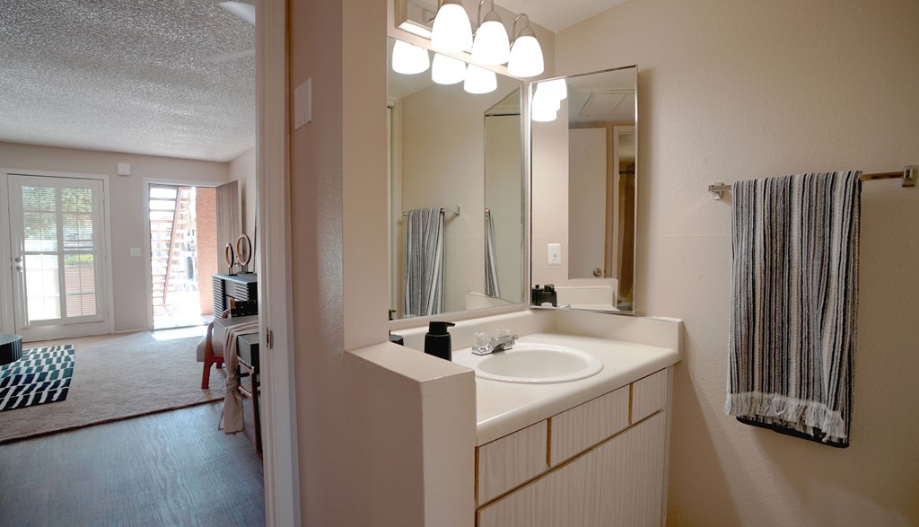A bathroom with a sink and mirror.