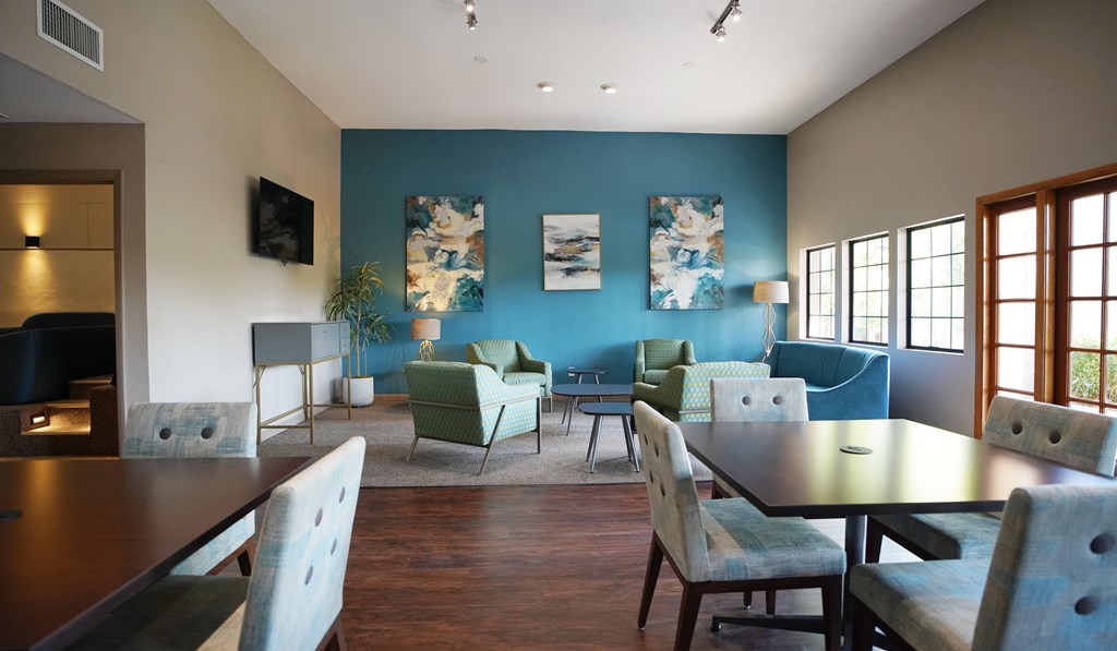 A dining room with a long table and chairs.