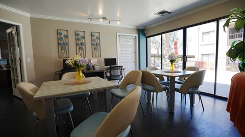 A dining room with a table and chairs.