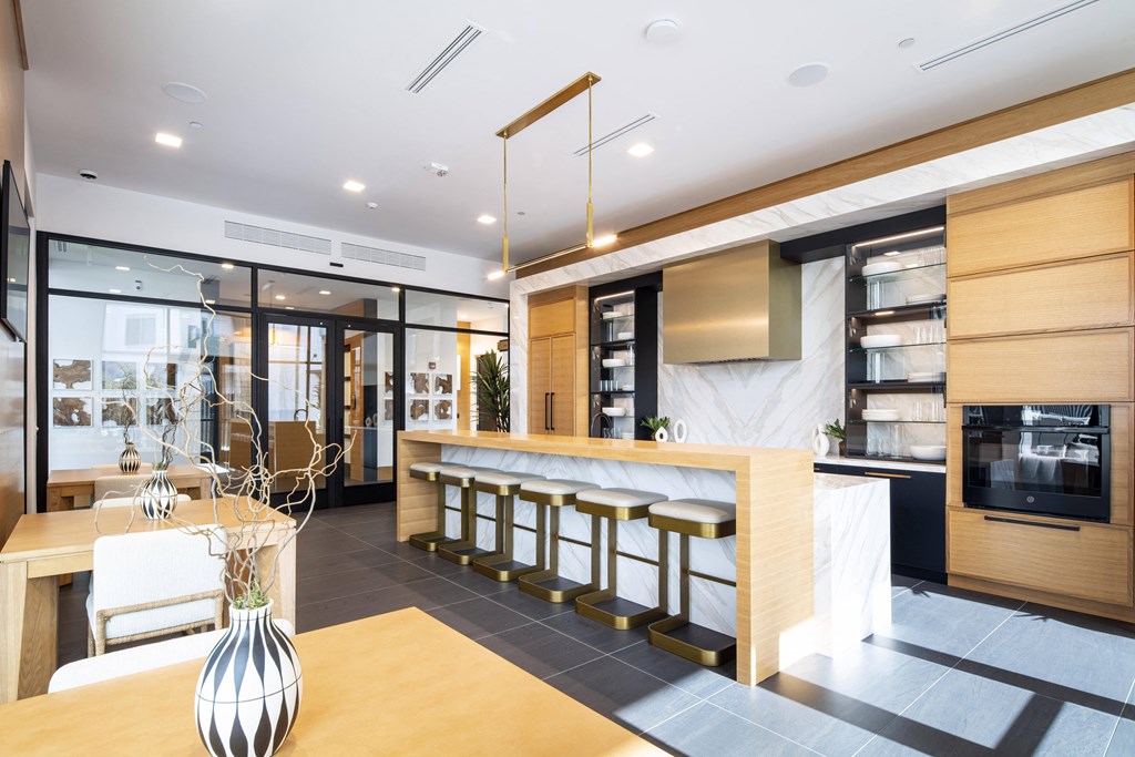 a kitchen and dining area with a bar and a table with chairs