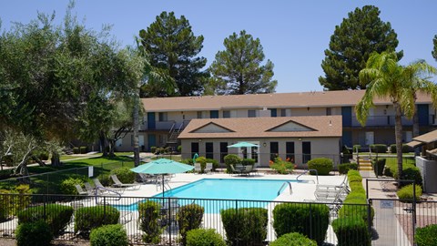 A large building with a pool in front of it.