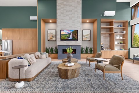 A modern living room with a fireplace and a grey sofa.