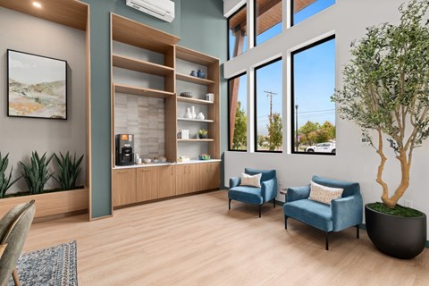 A modern waiting room with blue chairs and a wooden shelf.