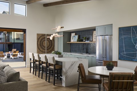 A modern kitchen with a dining table and chairs.