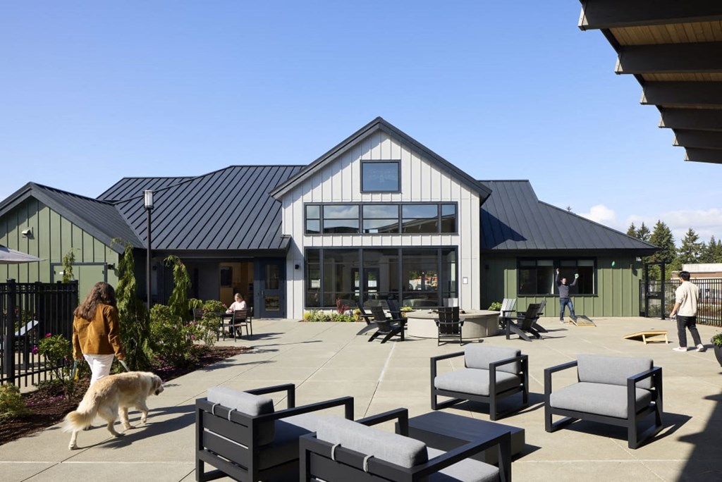 a dog walking on a patio in front of a building