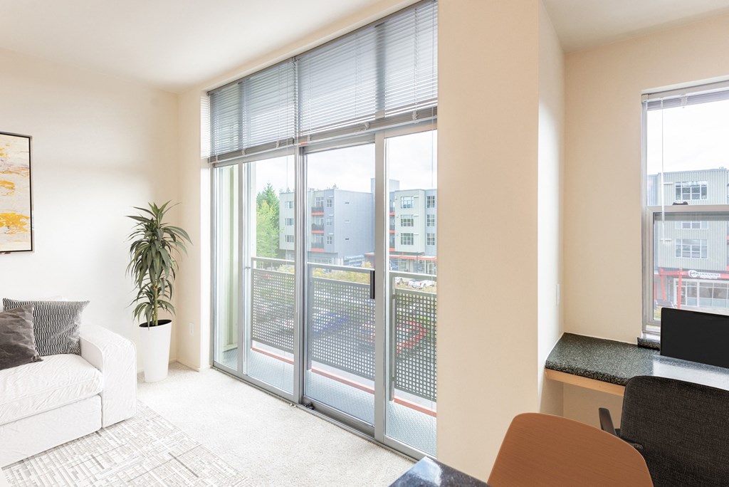 a living room with sliding glass doors to a balcony
