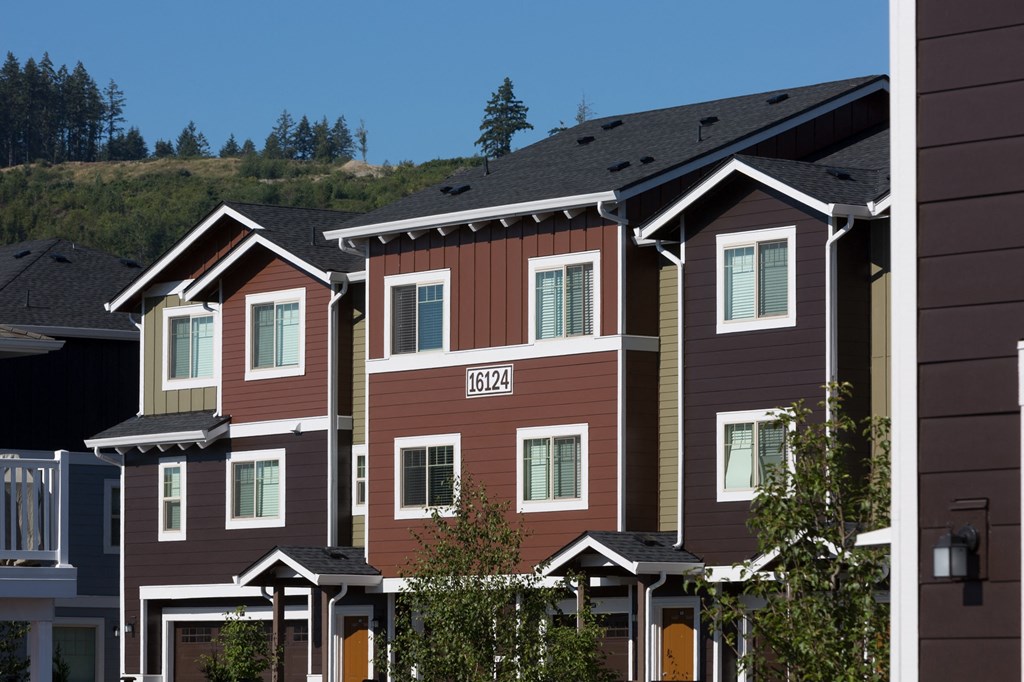 a row of houses with trees in front of them