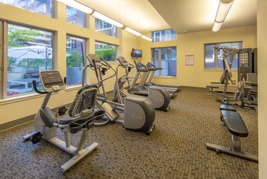 a gym with various exercise equipment in a large room