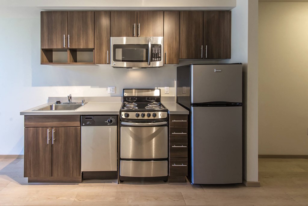 a kitchen with stainless steel appliances and wooden cabinets