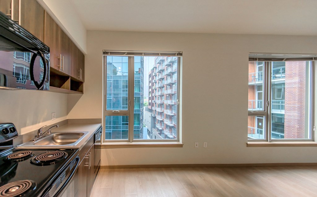 a kitchen with a large window and a stove and a sink