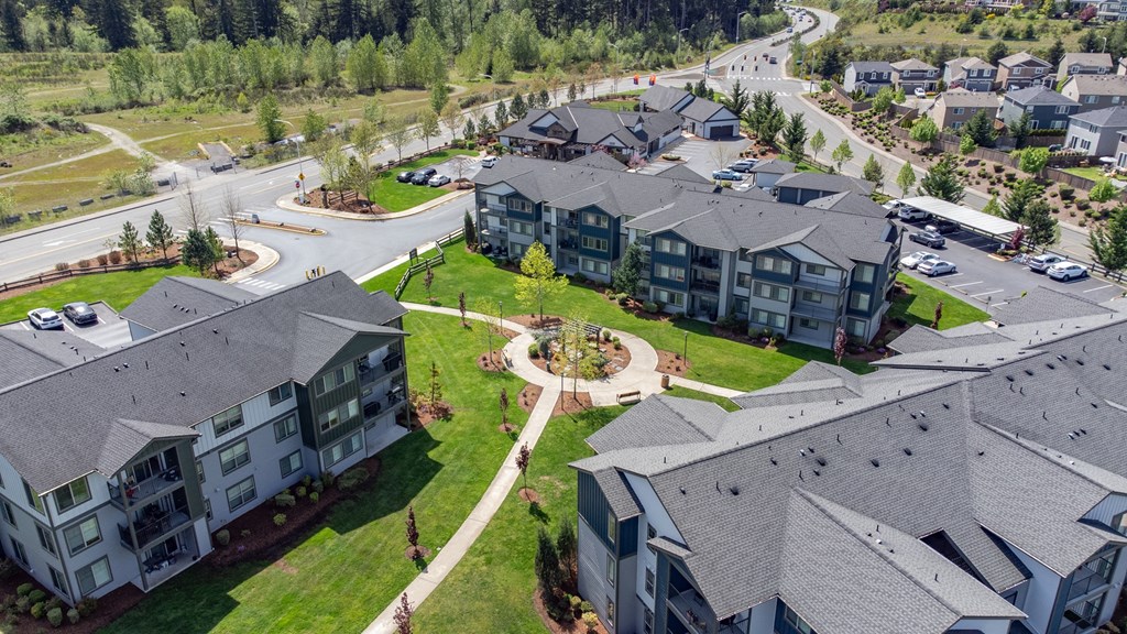 an aerial view of an apartment complex in a suburban neighborhood