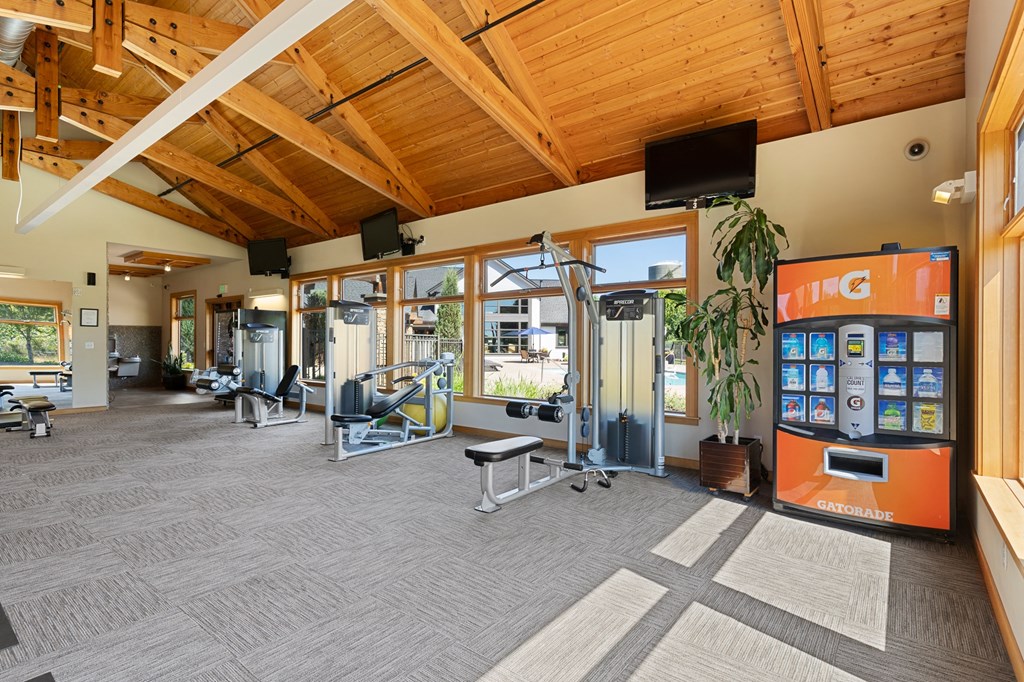 a gym with weights and cardio machines and a vending machine