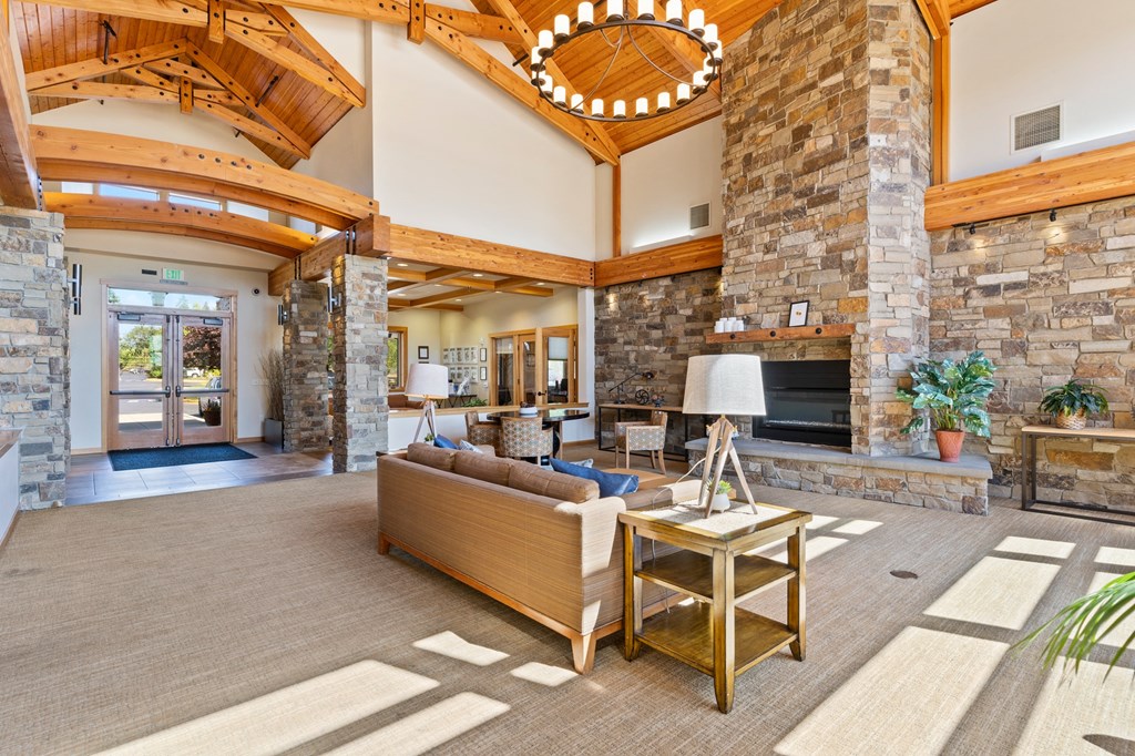 the living room of a house with a large stone fireplace