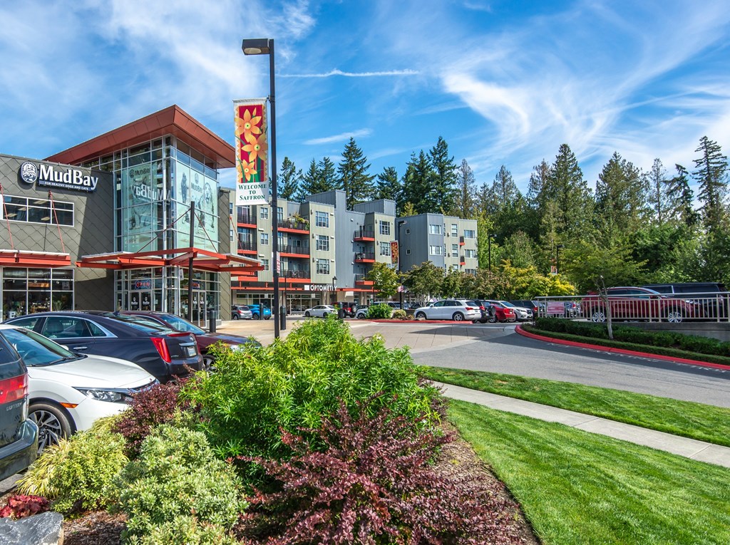 a city street with cars parked in front of a building