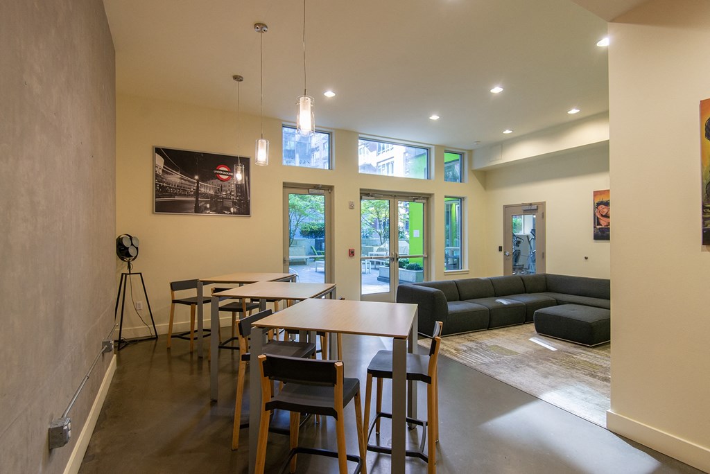 a dining room and living room with tables and couches