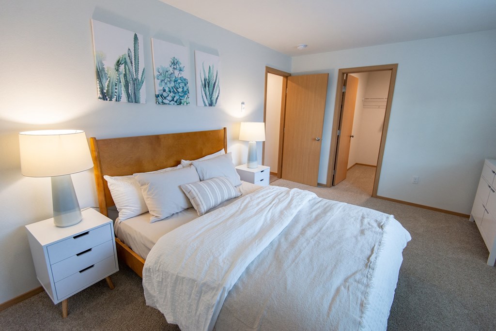 a bedroom with a large bed and a closet