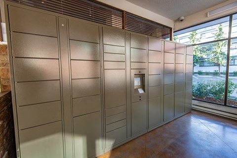 a large set of lockers in a room with a window