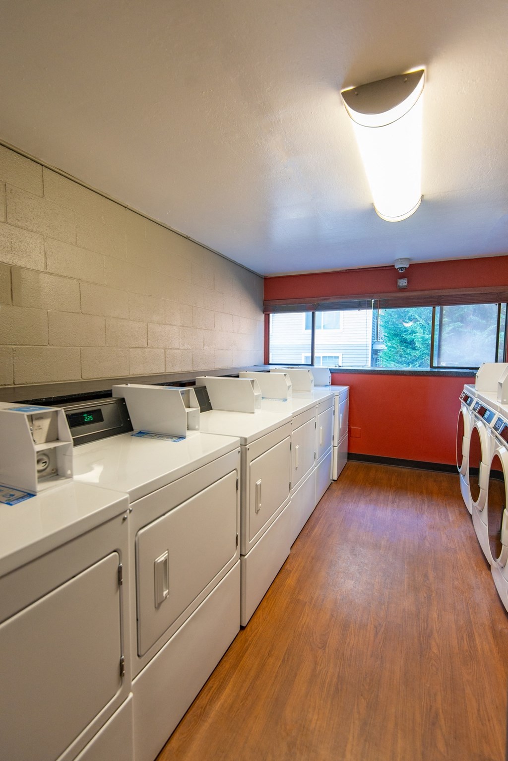 a kitchen with white appliances and a wood floor