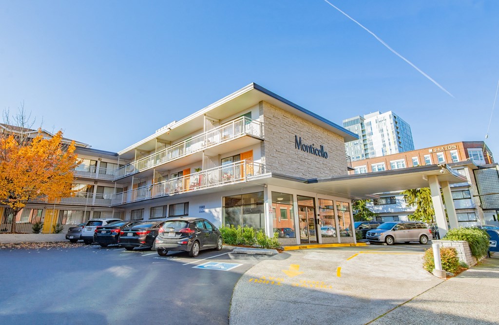 an apartment building with cars parked outside of it