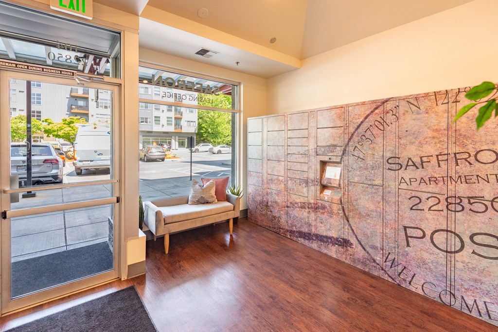 a lobby with a seating area next to a glass door